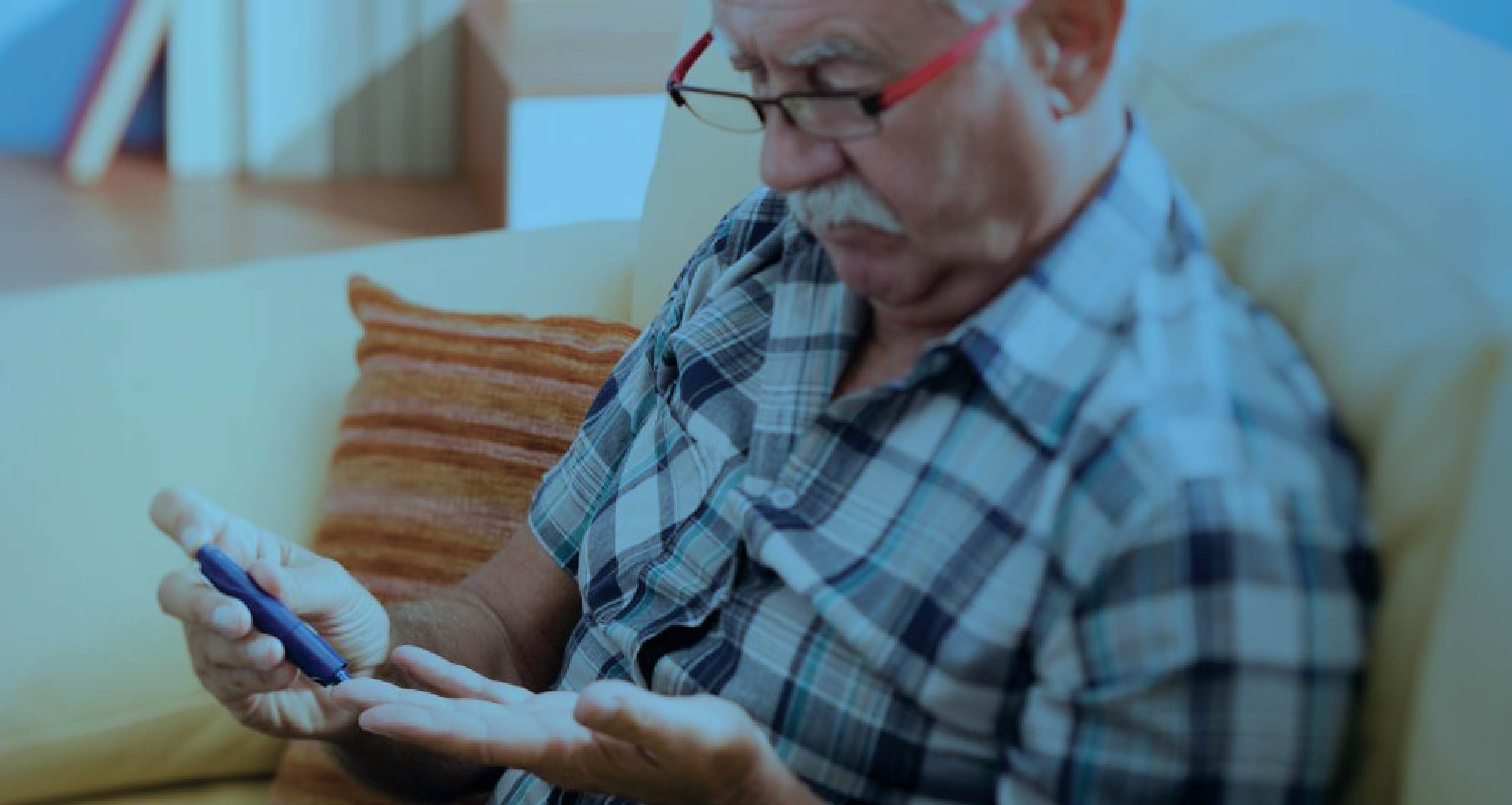 Older man testing blood sugar